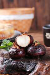 Fresh Roasted Water Chestnuts on Rustic Wood Board - Asian Cooking Ingredients