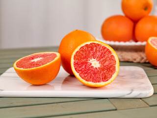 Fresh Red Blood Oranges Sliced on Marble Cutting Board Kitchen Counter
