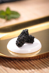 Dried Black Mulberries from Xinjiang China Closeup on Ceramic Plate Traditional Tea Ingredients