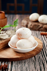 Fresh White Mushrooms on Wooden Cutting Board in Rustic Kitchen Setting