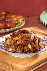 Air-Dried Duck with Sauce in Traditional Chinese Bowl on Bamboo Serving Tray
