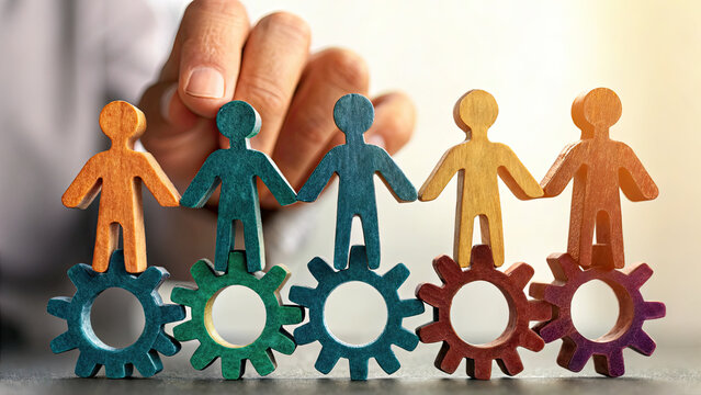 Adapt leadership style to meet the needs concept. A hand arranging colorful figurines on gear wheels symbolizing teamwork. - Powered by Adobe