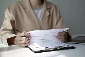 Businesswoman employer holding resume, recruiting, planning, evaluating and reviewing resume of job applicant, recruiting new employees, recruitment concept