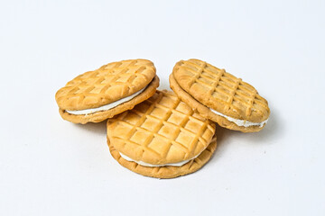 Close up view of three biscuits isolated on white background. clipping path. pile, stack. milk biscuits with jam and cream.