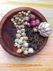 An arrangement of Indonesian spices that are a delicious and distinctive cooking spice, cooking spices arranged in a wooden mortar