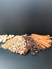 An arrangement of Indonesian spices that are a delicious and distinctive cooking spice, cooking spices arranged on a black base
