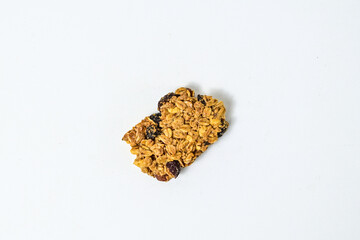 Delicious granola bar with almonds, oats, and dried cranberries, isolated on a white background. Top view, high angle, above, Close up. clipping path. piece. cracked. broken.