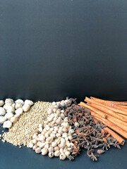 An arrangement of Indonesian spices that are a delicious and distinctive cooking spice, cooking spices arranged on a black base