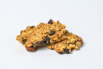 Delicious two granola bars with almonds, oats, and dried cranberries, isolated on a white background. Close up view. clipping path. piece. Flat lay. broken. pile, stack. cracked.