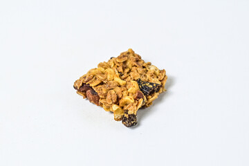 Delicious granola bar with almonds, oats, and dried cranberries, isolated on a white background. Close up view. clipping path. piece. cracked. broken.
