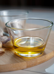 ingredients in a kitchen to prepare pasta Italian food a glass with olive oil extra virgin over a cutting board