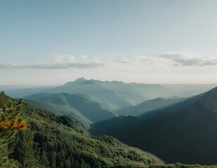 Obraz premium Breathtaking mountain landscape under soft evening light, showcasing layers of green hills.