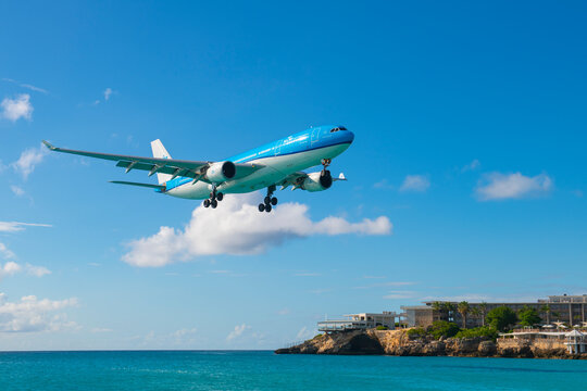 KLM Airbus 330-200 PH-AOA flying over Maho Beach before landing on Princess Juliana International Airport SXM on Sint Maarten, Dutch Caribbean. 