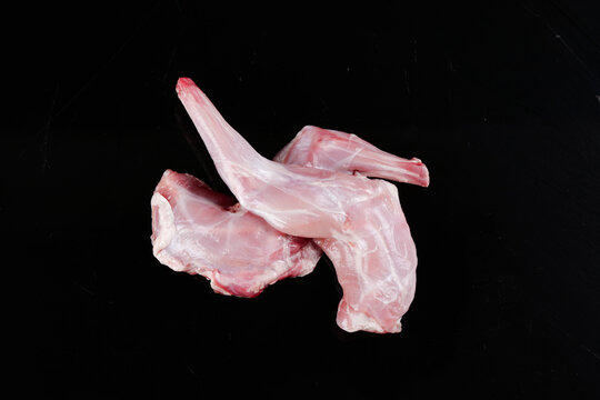 Raw Fresh Rabbit Foreleg Meat Cuts on Black Background