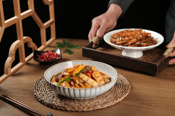 Stir-Fried Pork with Bamboo Shoots - Traditional Asian Cuisine in White Bowls on Wooden Table