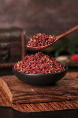 Dried Red Sichuan Peppercorns in Bowl with Wooden Spoon - Chinese Cooking Spice