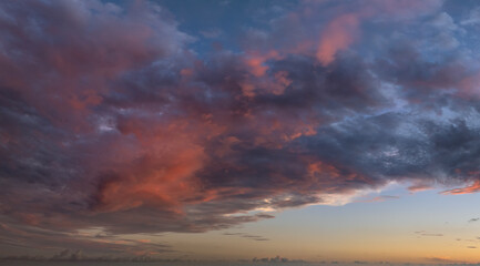Amazing sunset skyscape. Evening sky with bright colorful orange and yellow clouds