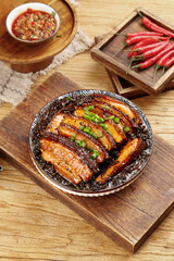 Traditional Homemade Braised Pork Belly with Preserved Vegetables and Red Chili Peppers on Rustic Wooden Board