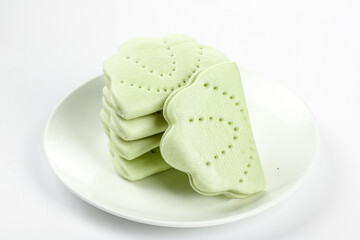 Handmade Traditional Green Lotus Leaf Shaped Sandwich Cakes Gourmet Asian Dessert on White Plate