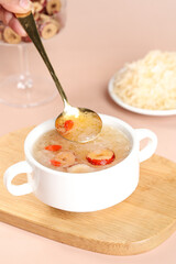 Creamy Mushroom Soup with Silver Spoon in White Bowl on Wooden Board