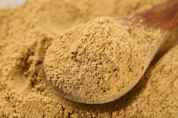 Golden Ginger Powder in Wooden Spoon - Natural Seasoning and Condiment for Cooking and BBQ