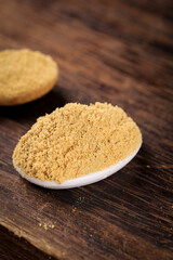 Fresh Ginger Powder Spice in Spoon on Wooden Table - Cooking Ingredient