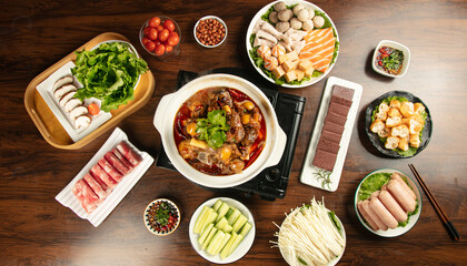 Asian Hot Pot Feast with Fresh Ingredients and Mushroom Balls on Wooden Table