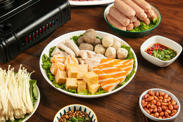 Hot pot ingredients with golden tofu strips croquettes and mushrooms ready for Asian cooking