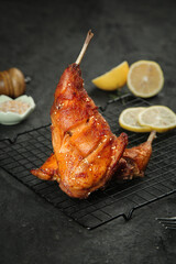 Szechuan Style Smoked Rabbit Legs Cold Dishes Chinese Cuisine Delicacy on Cooling Rack
