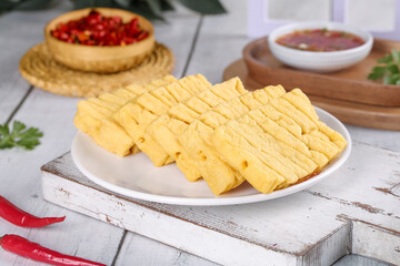 Dried Tofu Slices with Sauce on Rustic White Wooden Table Studio Shot