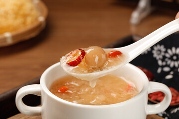 Sweet Asian Dessert Soup with Red Dates and Glutinous Rice Dumplings in White Bowl