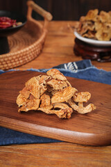 Authentic dried gourmet mushrooms on wooden cutting board - specialty food photography