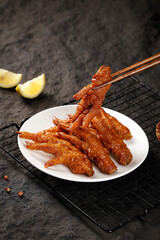 Marinated Chicken Feet in Soy Sauce Glaze Asian Snack Food with Chopsticks