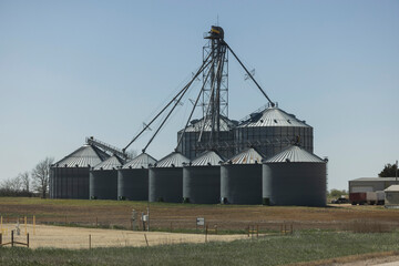 Fototapeta premium A steel grain elevator rises above the great plains in Lyons, Kansas, USA.