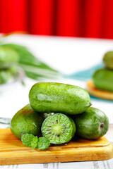 Fresh Green Kiwi Berries on Wooden Board - Healthy Fruit Closeup with Water Droplets