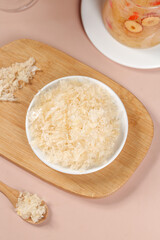Silver Ear Mushroom Fragments Ready to Eat - Tremella Fungus in Bowl on Wooden Board