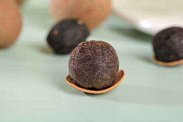 Dried Longan Fruit from Guangdong China on Wooden Spoons - Traditional Asian Health Food Ingredient