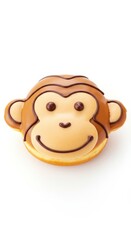 Fototapeta premium A delightful monkey-shaped donut, decorated with brown icing details and a cheerful expression, sits against a plain white background.