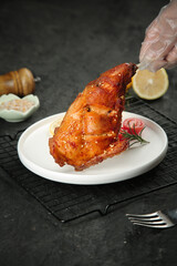 Szechuan Style Roasted Rabbit Leg with Golden Crispy Skin and Fresh Herb Garnish