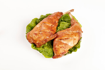 Roasted Rabbit Legs with Spicy Seasoning on Lettuce Leaves - Traditional Meat Dish