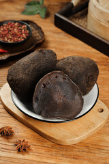 Black Daikon Radish with Traditional Chinese Spices on Wooden Board