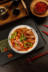 Szechuan Style Spicy Smoked Sausage Stir-Fry with Peppers - Traditional Chinese Cuisine on Wooden Serving Tray