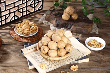 Fresh Xinjiang Walnuts in Bamboo Basket on Rustic Wooden Table with Traditional Chinese Paper