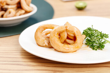 Crispy Fried Squid Rings with Parsley Garnish - Delicious Seafood Appetizer Snack