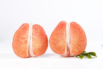 Fresh Ruby Red Thai Pomelo Halves with Pink Flesh on White Background