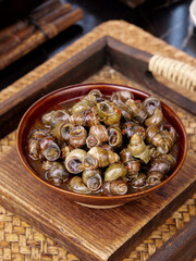 Spicy Whelk Sea Snails Stir Fry in Ceramic Bowl Asian Seafood Delicacy on Bamboo Serving Tray