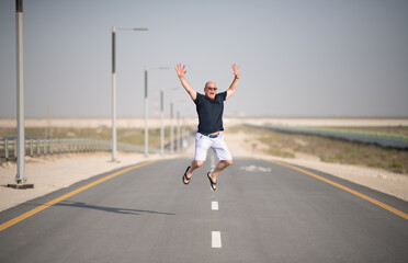 Man Walking on Desert Highway