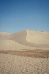 Mingsha Mountain and Crescent Lake in Dunhuang, Gansu Province - Desert scenery under clear sky, Background texture and minimalist concept.