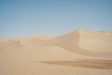 Mingsha Mountain and Crescent Lake in Dunhuang, Gansu Province - Desert scenery under clear sky, Background texture and minimalist concept.