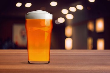 Glass of chilled tasty beer on bar tabletop